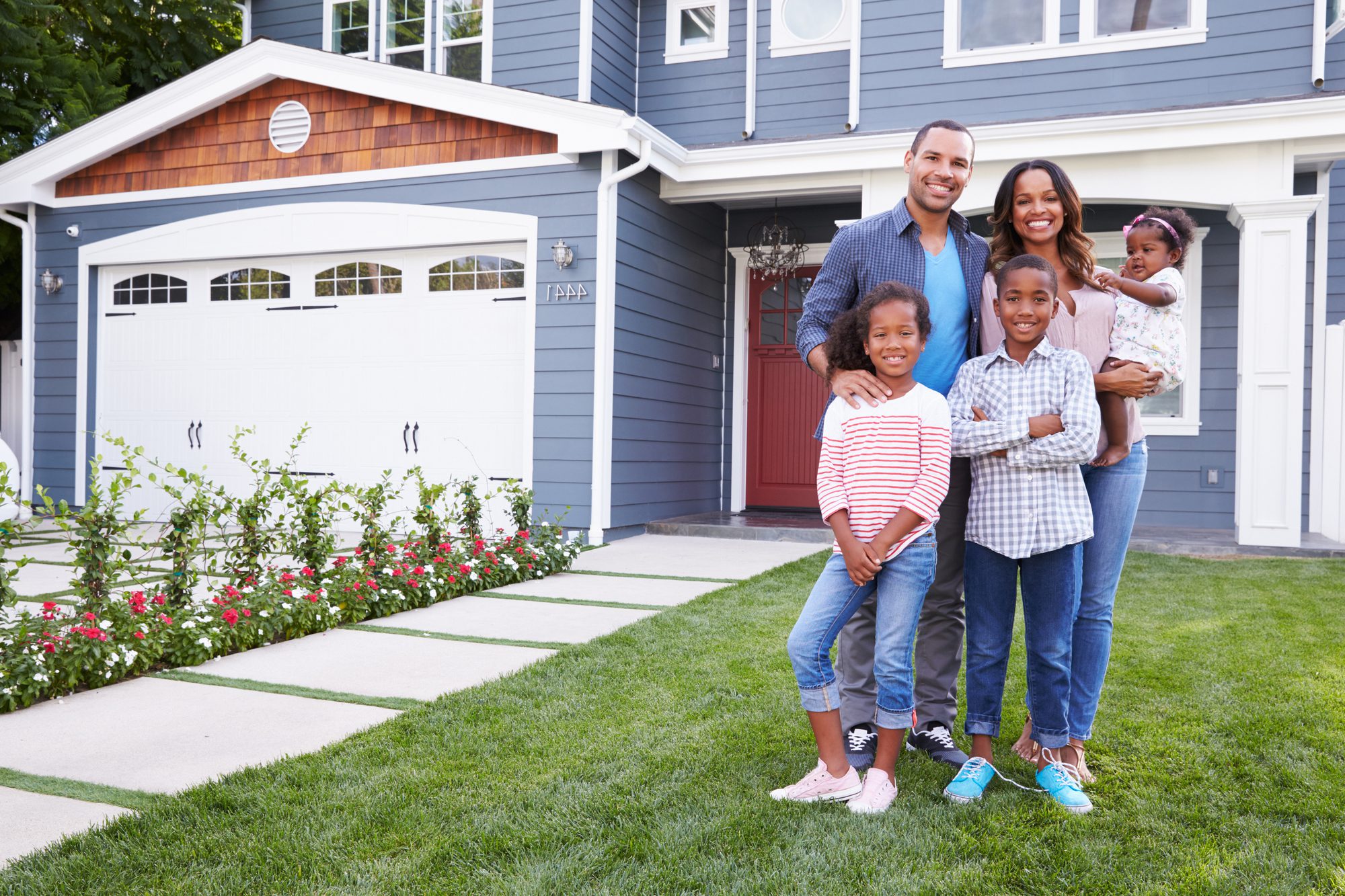 Happy Family Standing Out Their House